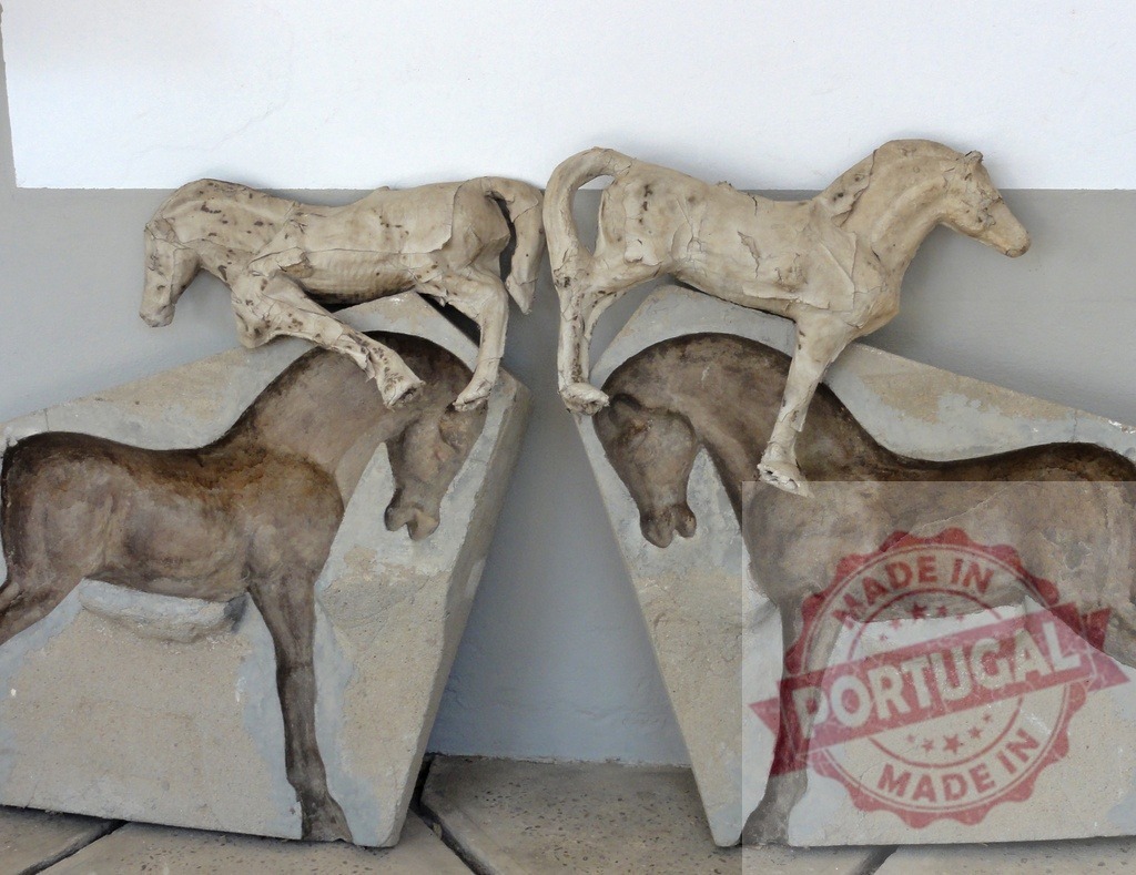 Horse statue plaster molds and casts | Plaster casts of horse sculptures resting on their molds, showing artistic process - Realized with Pictrs.com