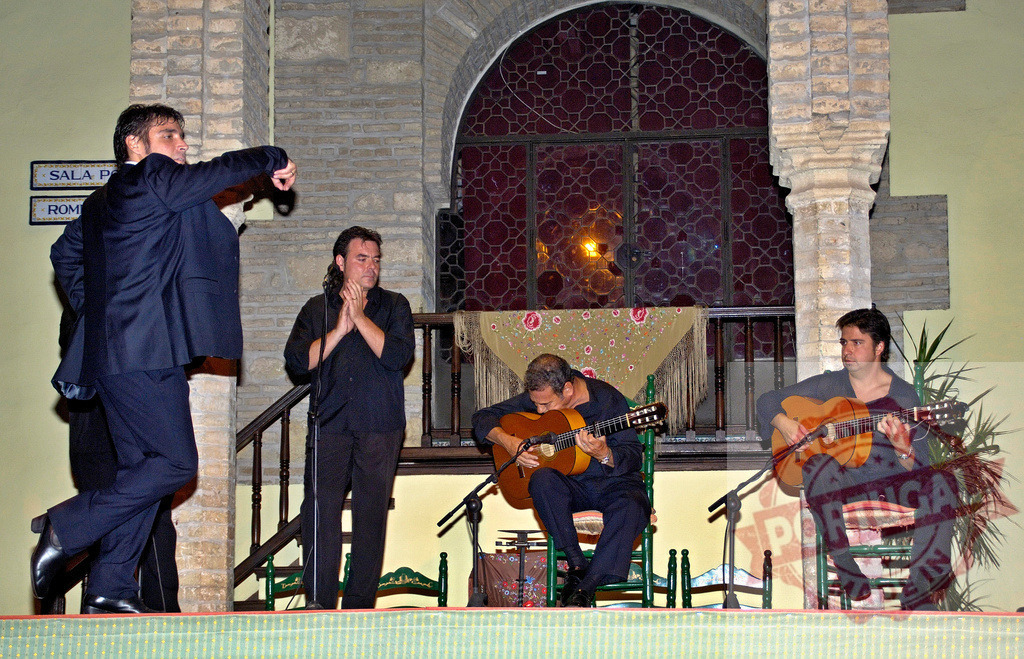 Flamenco dancer performing on stage with guitarists in Spain | Flamenco dancers and musicians performing traditional Spanish music and dance - Realized with Pictrs.com