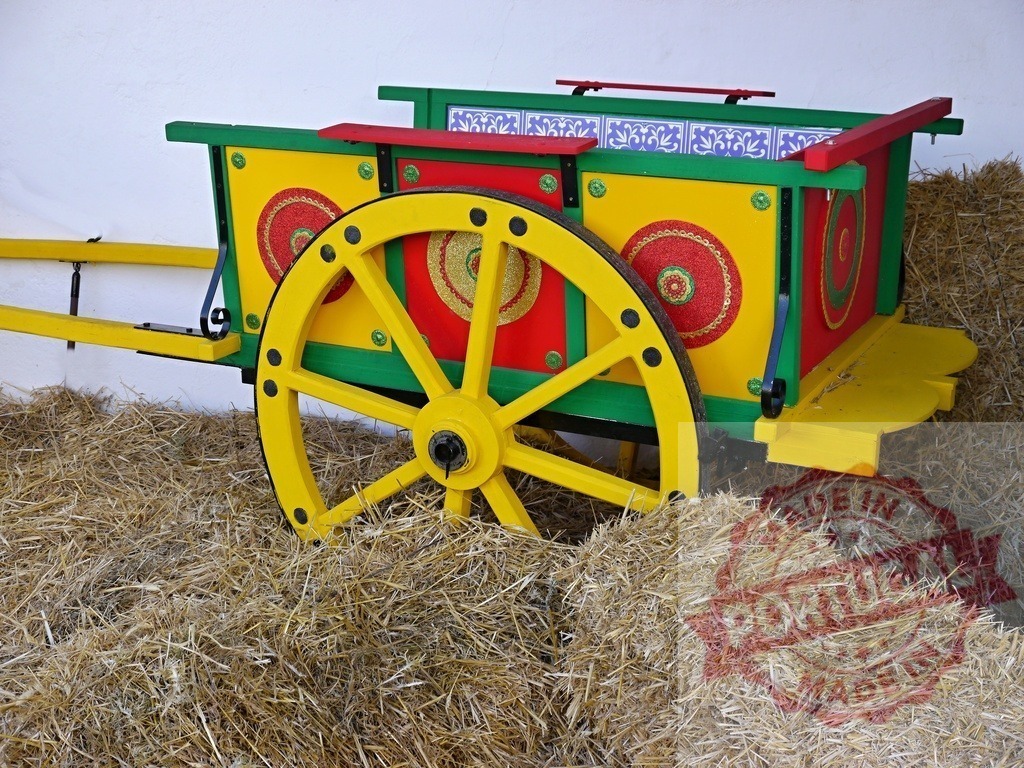 Sicilian cart showing colorful folk art tradition | Sicilian cart with painted wooden wheel standing on hay bales, representing folk art and culture - Realisiert mit Pictrs.com