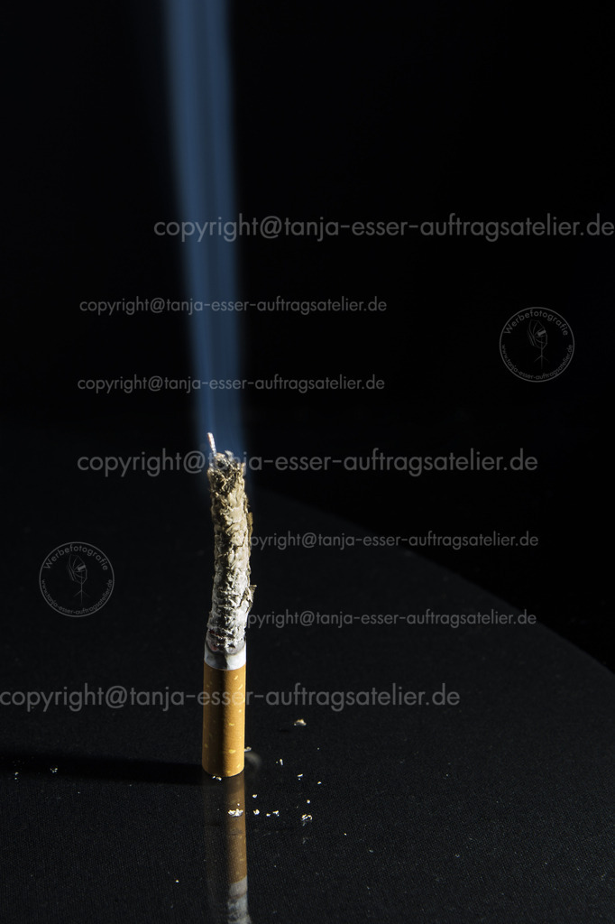 Standing cigarette burns and generates blue smoke | Standing cigarette burns and generates blue smoke