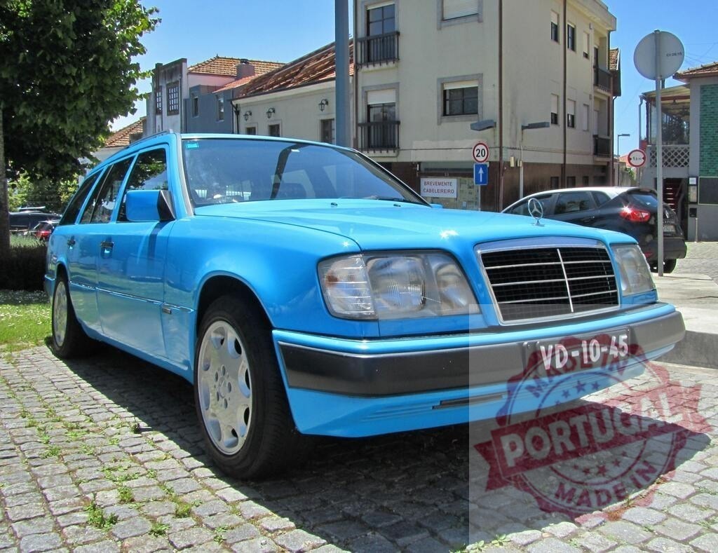 Light blue Mercedes-Benz w124 estate car parked in cobblestone street | Light blue Mercedes-Benz w124 estate car parked in cobblestone street in urban environment - Realized with Pictrs.com