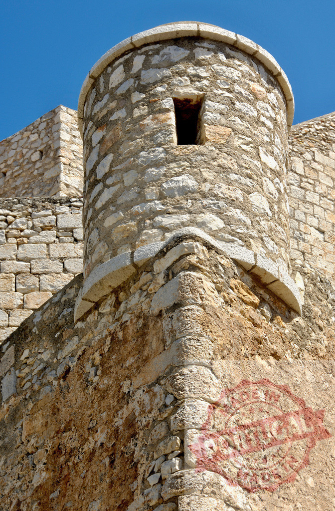 Peniscola Castle fortress walls and ancient stone tower. Provincia de Castellon | Ancient stone fortress walls and a defensive tower standing against a clear blue sky - Realisiert mit Pictrs.com