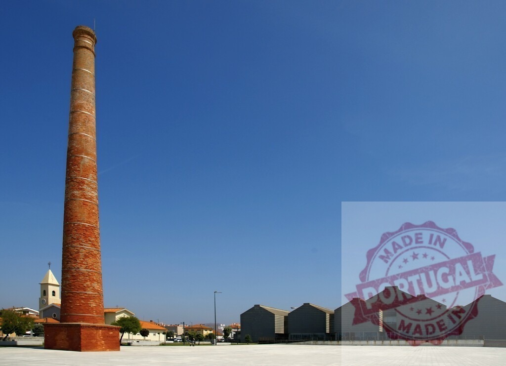 Aveiro Region - Portugal Old brick chimney standing in urban landscape | Old industrial brick chimney rising against a clear blue sky in an urban landscape - Realized with Pictrs.com