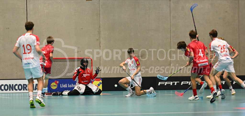 Switzerland B U19 vs Switzerland U19 - 4. February 2024 | Switzerland B U19 vs Switzerland U19
U19 Men International Matches in Switzerland
GoEasy Arena, Siggenthal Station
Switzerland forward #16 Dario Bürgler scores against Switzerland goalie #1 Eric Kunz.
Credit: Markus Aeschimann | <a href="https://www.markus-aeschimann.ch">Sportfotografie Markus Aeschimann</a> | <a href="https://www.instagram.com/sportfotografie.aeschimann">@sportfotografie.aeschimann</a> - Realisiert mit Pictrs.com